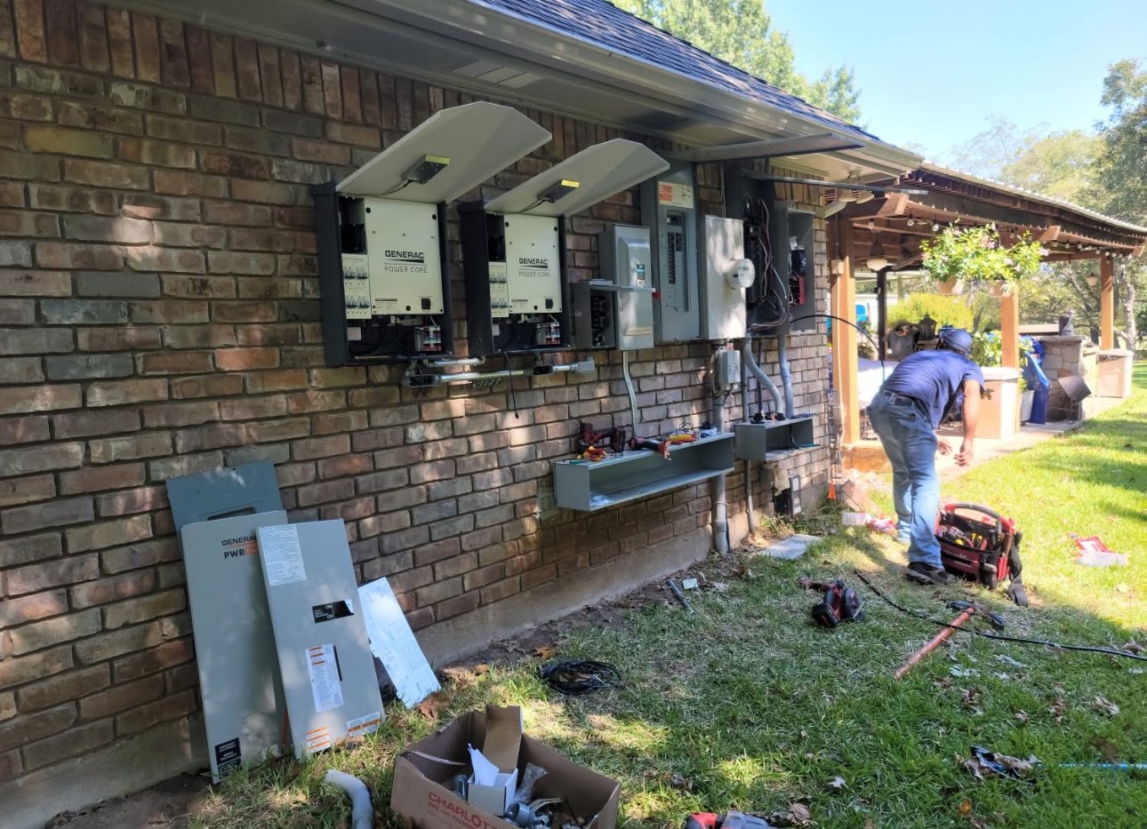 Technician performing electrical service work on a home's solar and backup power equipment