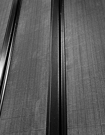 Close-up finish detail of matte-black solar collectors and rail system